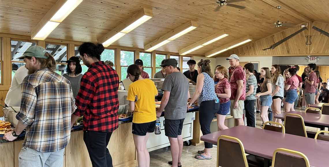 people serving food at Itasca's dining hall