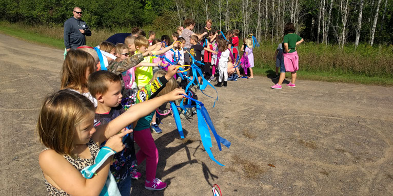 students hold streamers and complete a wind and weather experiment