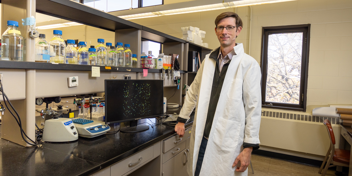 Will Harcombe standing in the lab