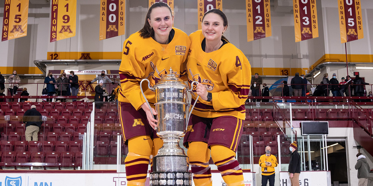 Audrey and Madeline Wethington on the ice with trophy