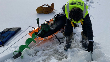Swanner conducts field work on frozen lake 