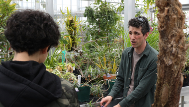 Jared Rubinstein showing students plants in the CBS Conservatory