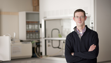 Will Harcombe standing in the lab