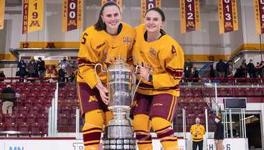 Audrey and Madeline Wethington on the ice with trophy
