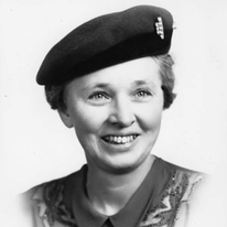 a black and white picture of a white woman in a beret smiling